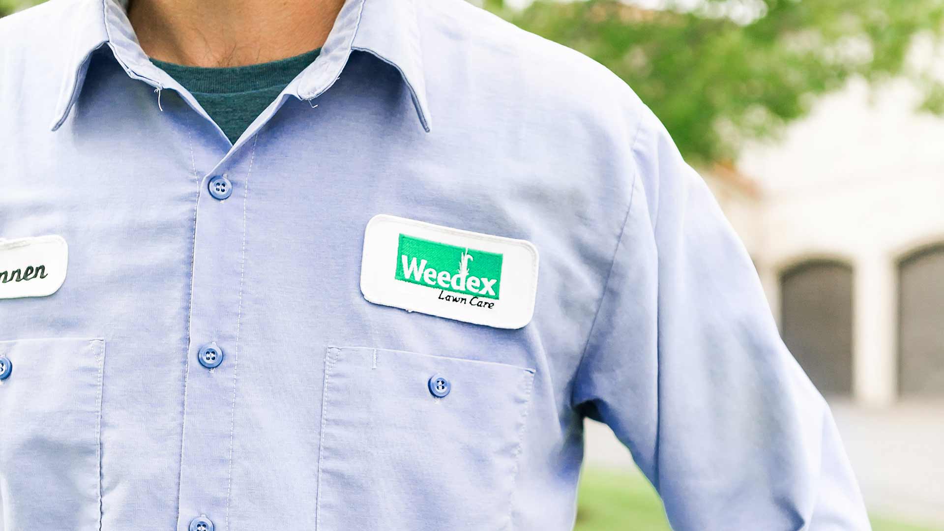 Weedex Lawn Care employee wearing a uniform with logo near Plano, Texas.