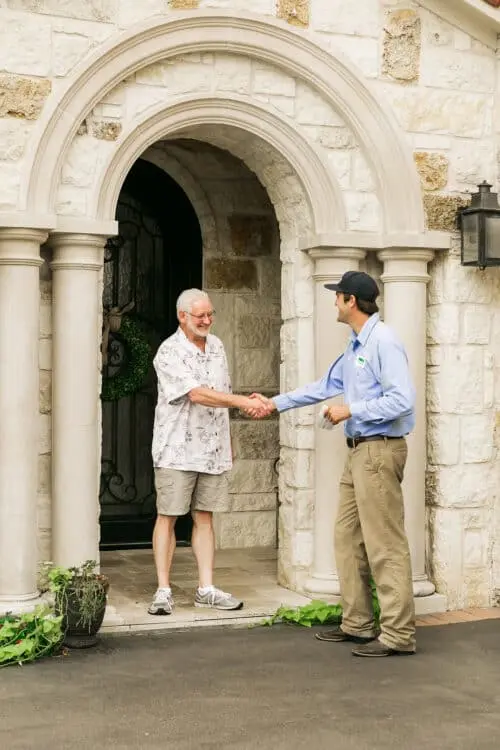 Happy Weedex customer greeting a lawn technician at their home