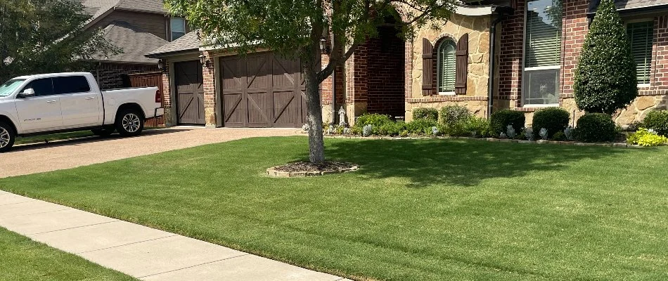 Green lawn with truck in the driveway on a property in Red Oak, TX.