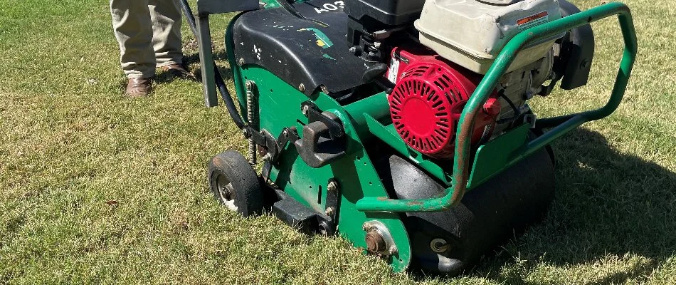 Green aeration machine on a lawn in Justin, TX.