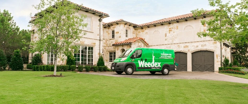 Home in Bedford, TX, with green lawn and work truck in driveway.