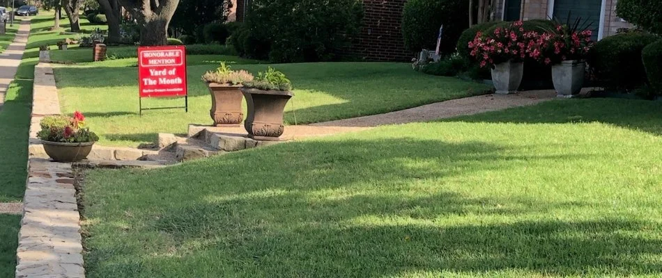 Lawn with red yard sign in Prosper, TX.