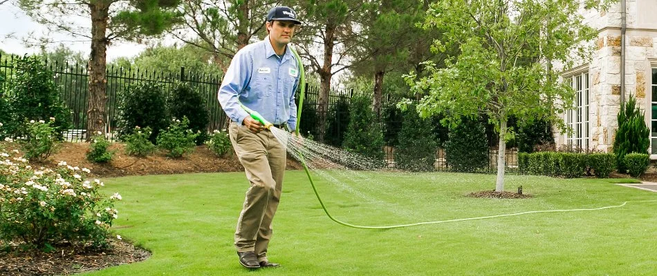 Liquid fertilizer treatment being sprayed on grass in Pelican Bay, TX.